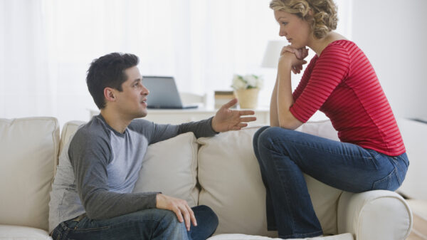 Couple talking on sofa